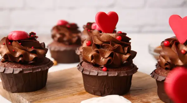 Gourmandes bouchées au chocolat, décorées de cœurs rouges et de perles, parfaites pour un dessert romantique facile.