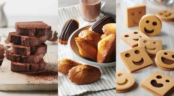 Tranches de cake au chocolat, madeleines et biscuits souriants. Parfait pour une recette goûter gourmande.