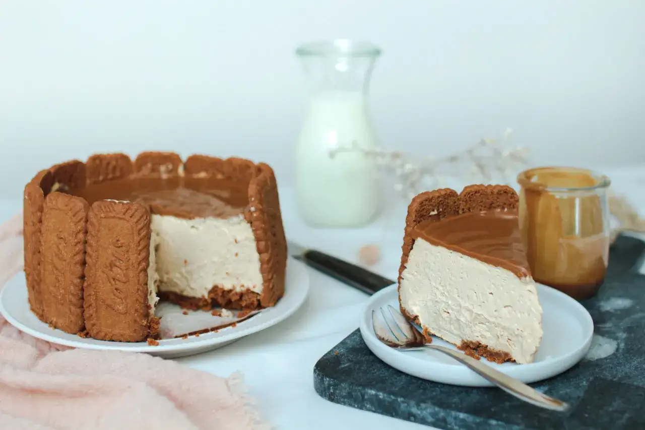Un délicieux gâteau spéculoos sans cuisson, avec une tranche servie sur une assiette, prêt à être dégusté.