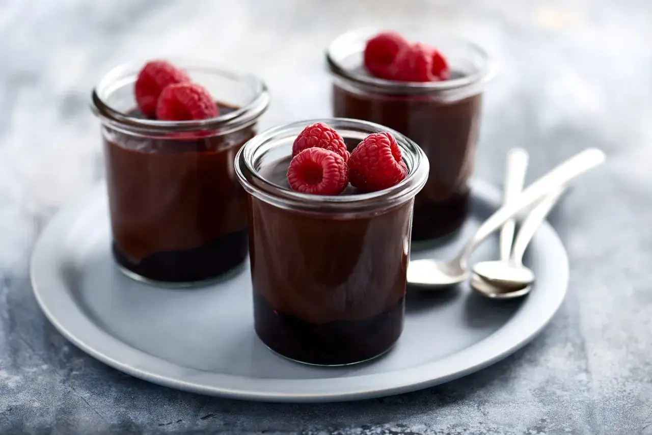 Trois pots de chocolat et framboises, un dessert romantique facile, parfaits pour partager un moment doux.